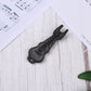 Black plastic guitar string puller tool on sheet