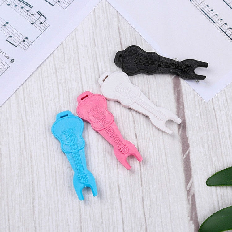 Assorted plastic guitar string pullers in black, white, pink, and blue