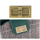 Gilt metal handbag lock clasp on green leather tab and tweed strap