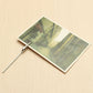 Metal wire rope alligator clip fastening a photo card