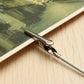 Close-up of silver metal wire rope alligator clip gripping photo edge