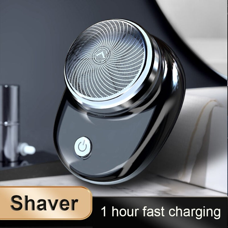 Compact electric shaver showing round foil head and front power button on dark handle.