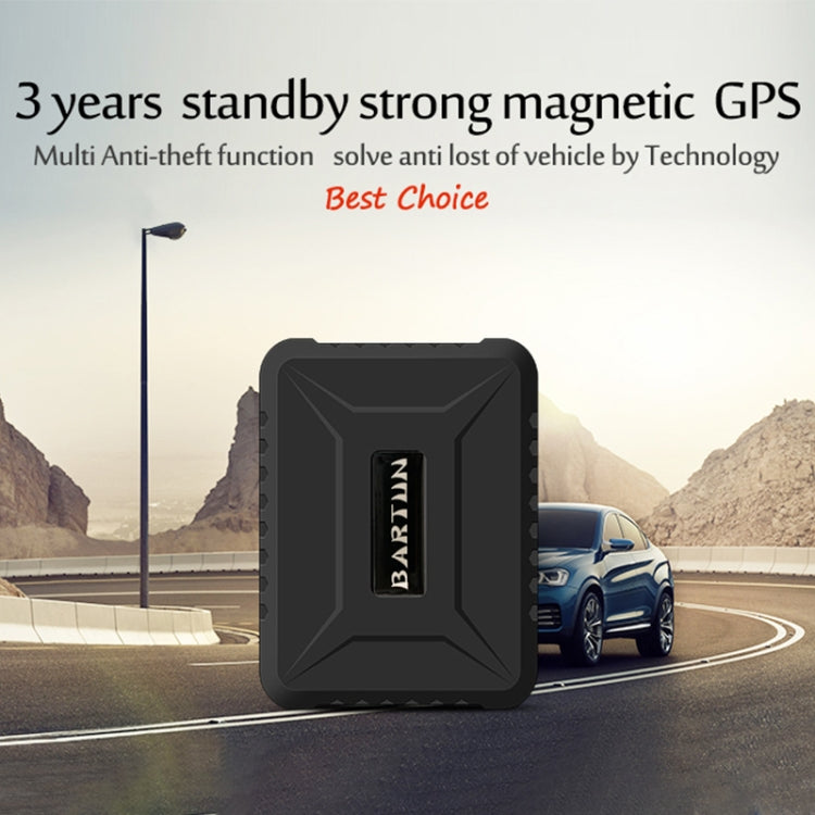 Black GPS vehicle tracker in protective case near a parked car