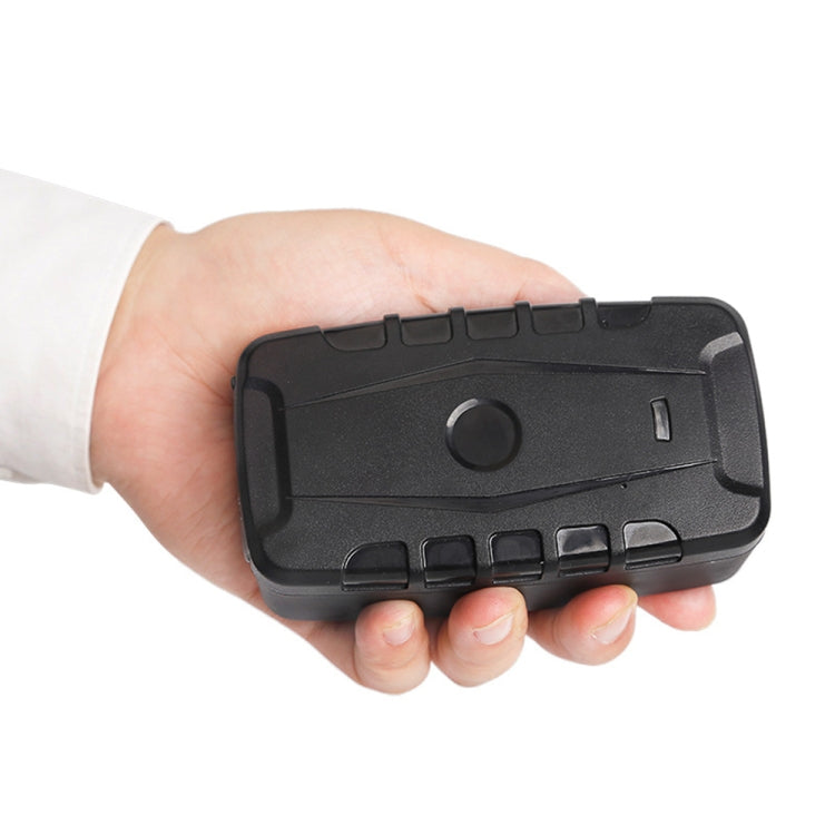 Black GPS tracker held in hand, compact weatherproof housing