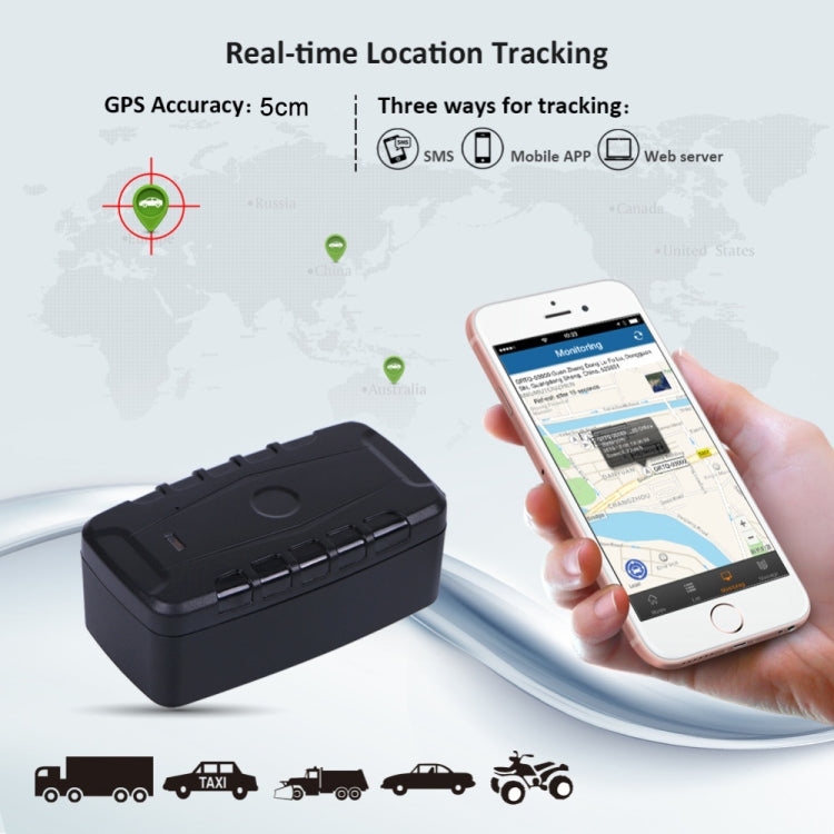 Black GPS tracker resting on vehicle surface, shown near a smartphone