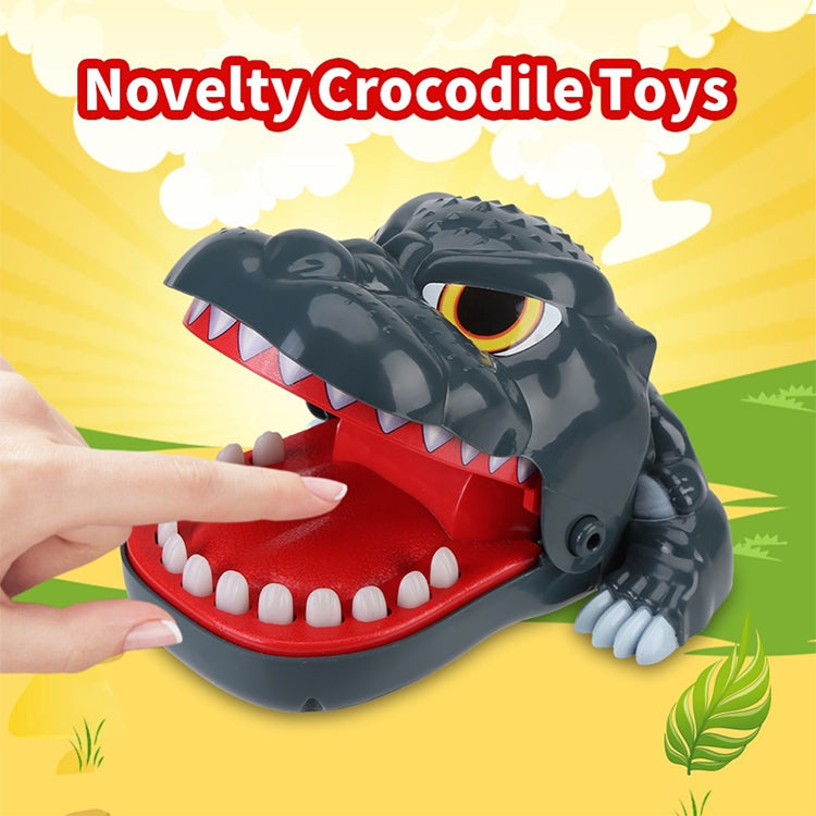 Gray dinosaur bite toy held by hand, open mouth over red base with white teeth