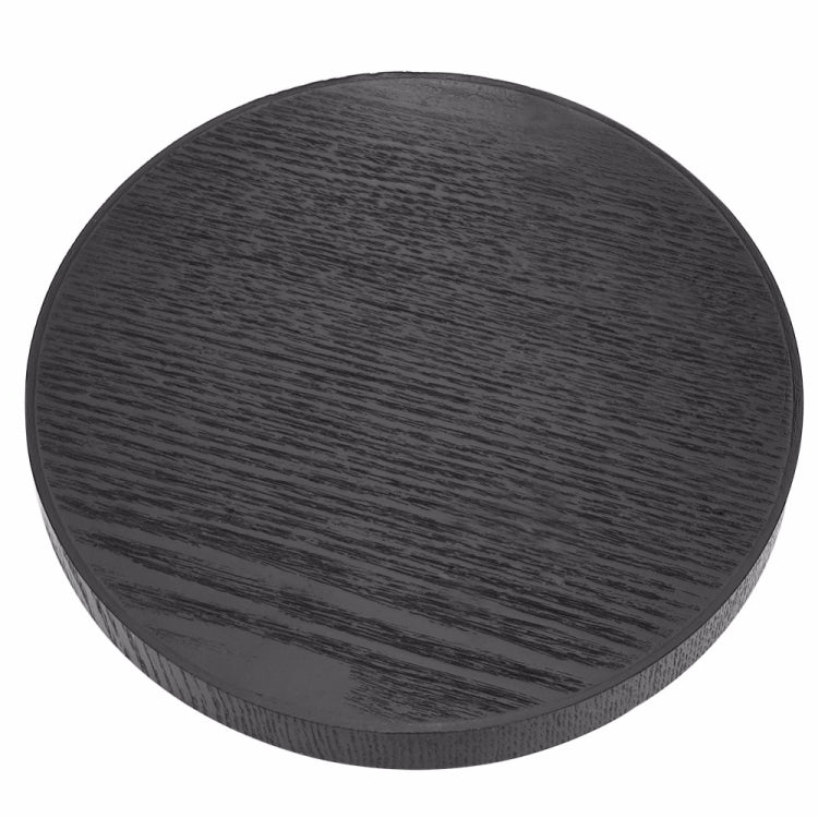 Black round wood tea tray with dark lacquer sheen and strong linear woodgrain pattern