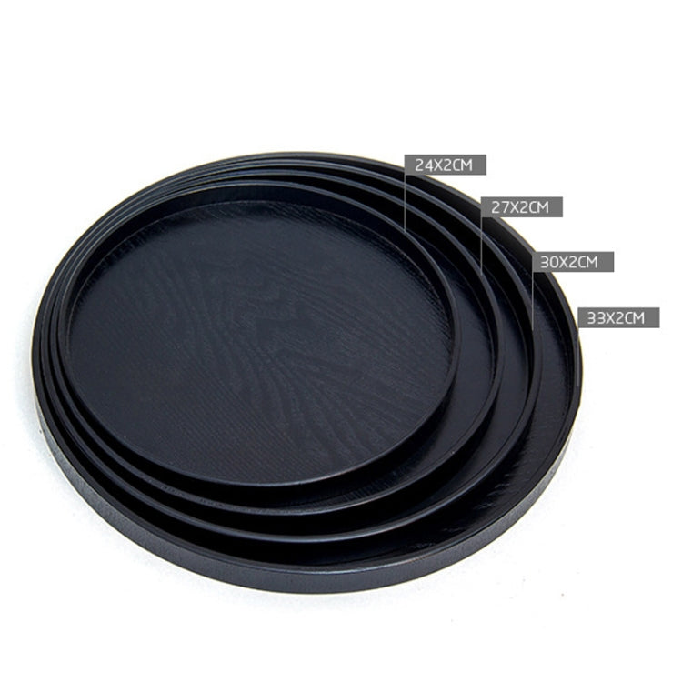 Set of three black round wood trays, nested together with flat centers and raised rims