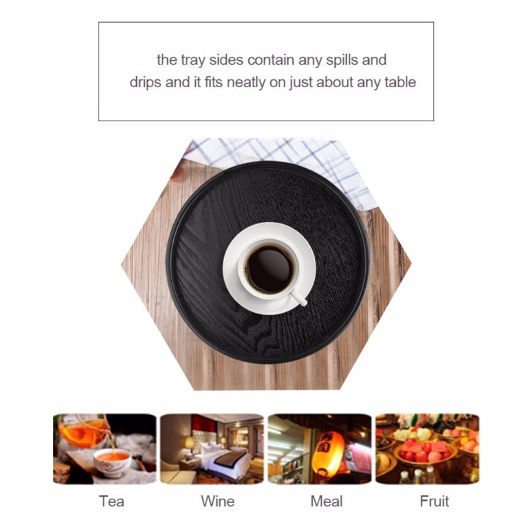 Black round wood tea tray with center cup, raised sides for drip control