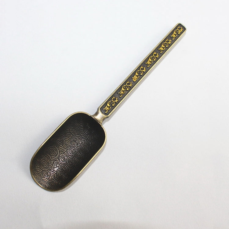 Long-handled tea spoon with gold filigree band and embossed dark swirl bowl