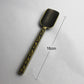 16cm tea spoon with gold filigree handle and embossed dark swirl bowl