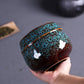 Teal ceramic mini tea storage can with speckled glaze and knobbed lid.