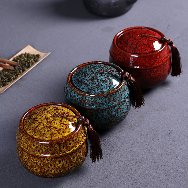 Ceramic tea storage cans set: red and teal plus yellow can with tassel pulls.
