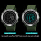 Digital outdoor wristwatch with green rubber strap, silver bezel, green illuminated display