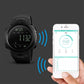 Black Bluetooth sports smartwatch showing steps next to smartphone fitness stats