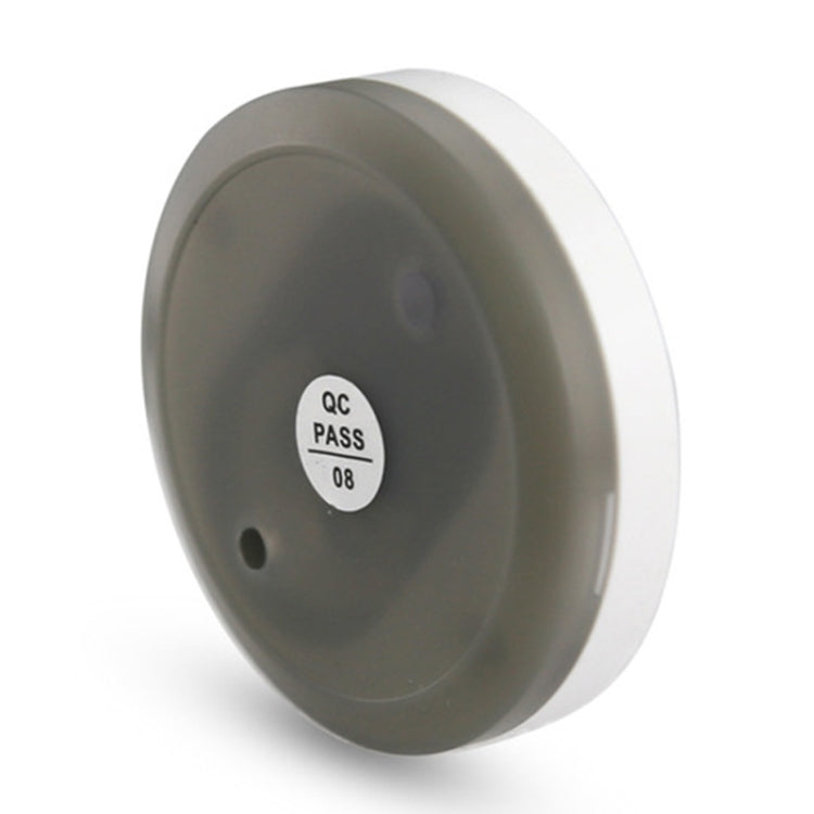 Grey back of wireless doorbell button with ID label and mounting hole
