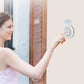 Person pressing a round white wireless doorbell button with bell icon