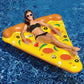 Inflatable pizza slice pool float with yellow deck and orange rim, woman relaxing on top
