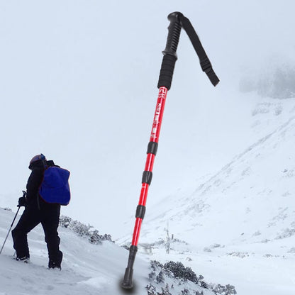 Red trekking cane with black grip, wrist strap, and four-section straight shaft