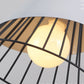 Close-up of white bulb inside black metal cage pendant light with wood top.