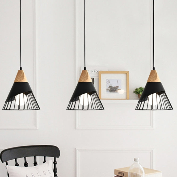 Set of three pendant lights with wood tops and black metal cage shades on cords.