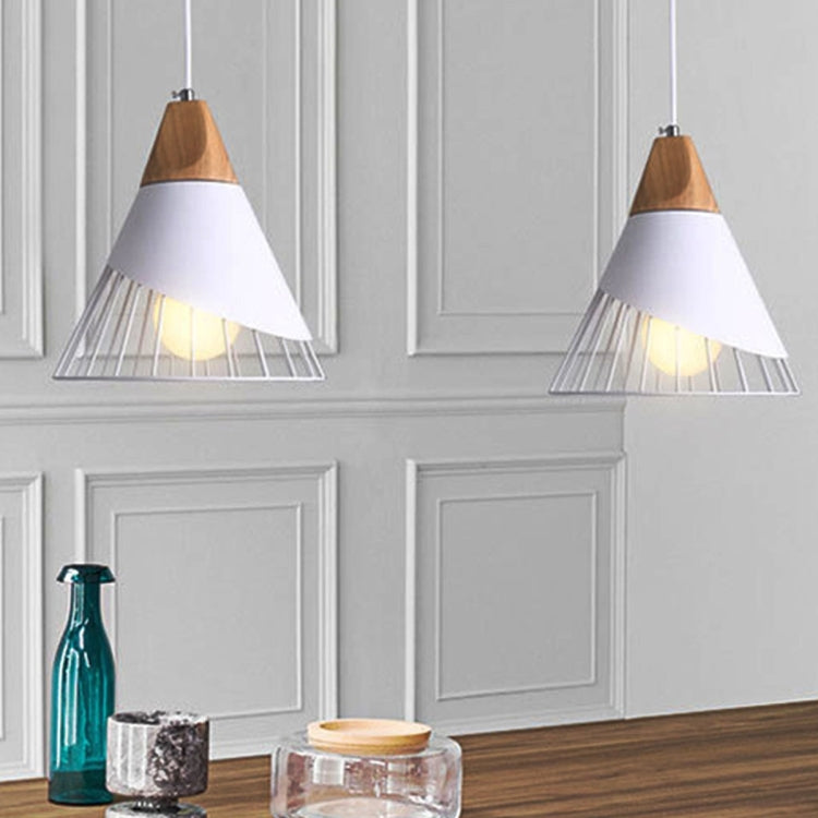 Two pendant lights with wood caps and black metal cage shades in a white room.
