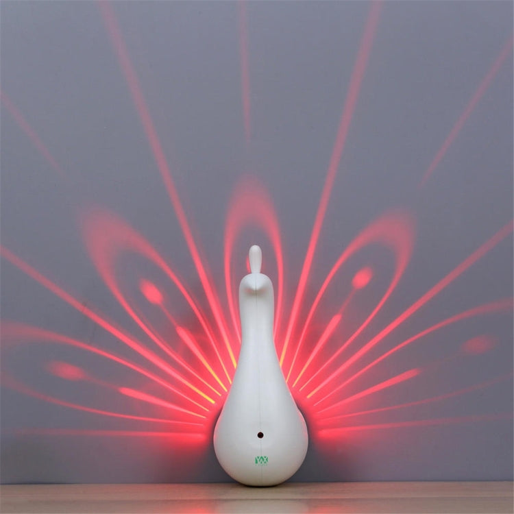 Peacock-shaped LED night light glowing with red light rays behind it