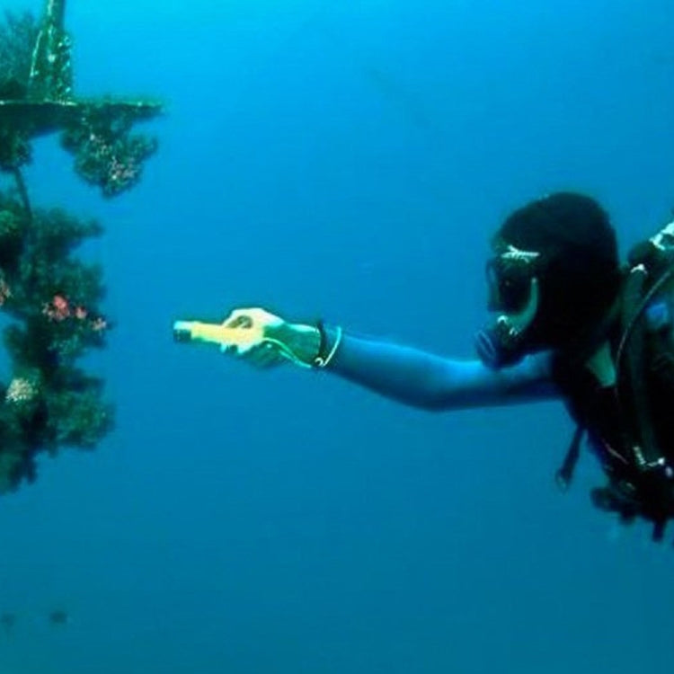 Underwater LED flashlight held by diver, casting a narrow white beam in water.