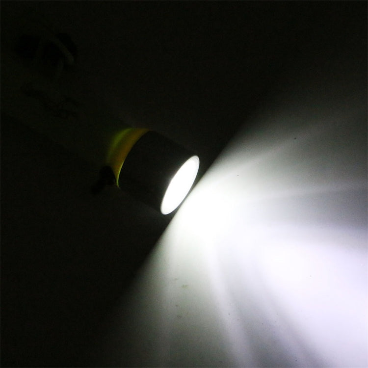 Beam from neon yellow underwater LED flashlight illuminating surrounding water.