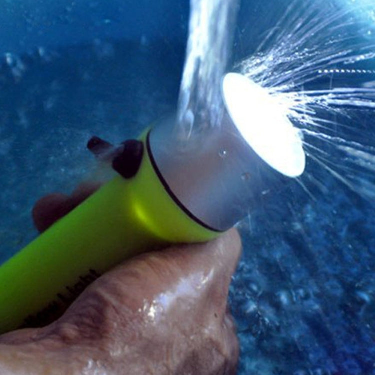 Hand holding neon yellow underwater LED flashlight; bright beam shines through splashes.