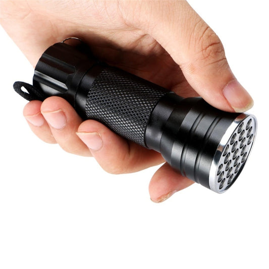 Handheld black UV LED flashlight with textured grip, wrist strap, and front LED panel.