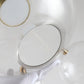 Clear glass globe lamp detail with gold socket hardware and metal mounting ring