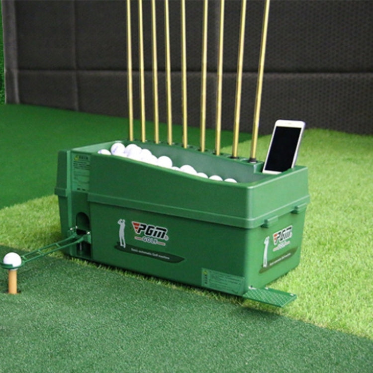 Green golf ball machine on turf with open tray of white balls and a smartphone