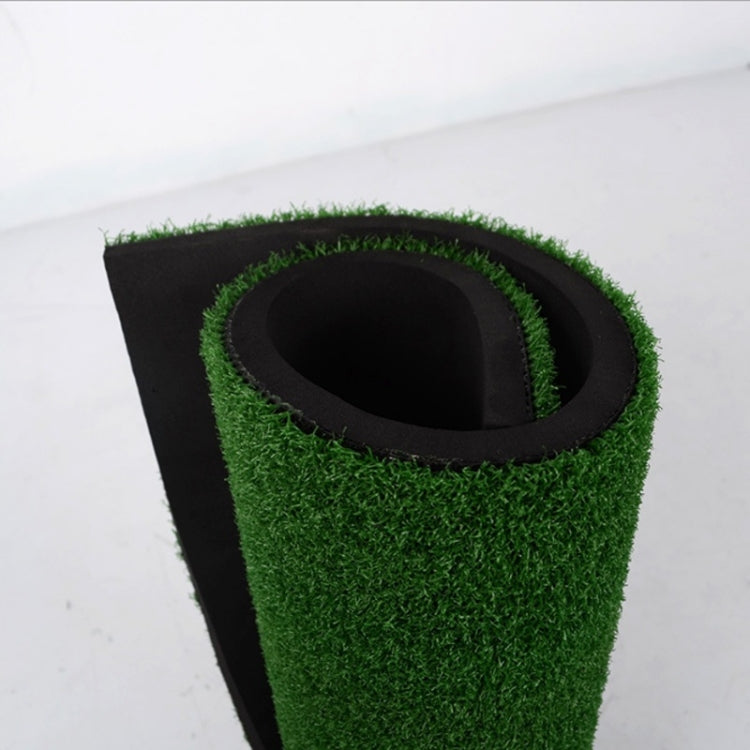 Golf practice mat corner with built-in target hole ringed by green turf