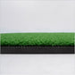 Green turf hitting surface of a golf practice mat with dark foam border