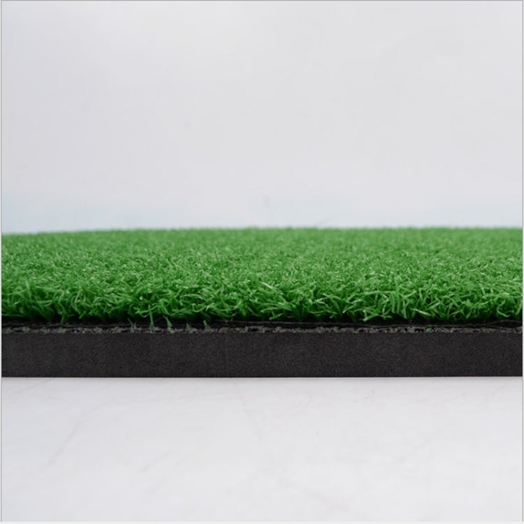 Green turf hitting surface of a golf practice mat with dark foam border