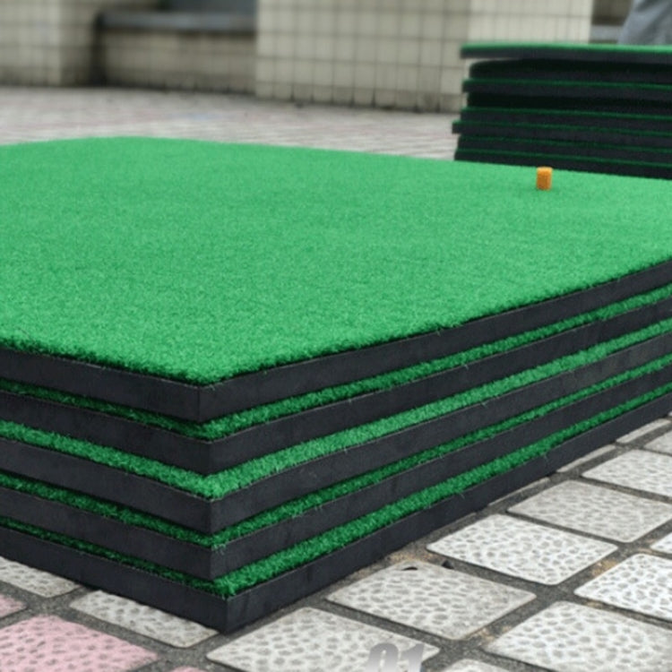 Stacked portable golf practice mats with green turf and layered dark foam sides