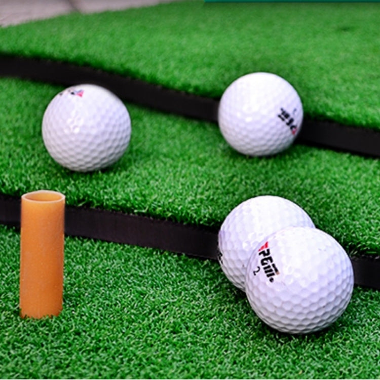 Golf practice mat with green turf and white golf balls near a tee