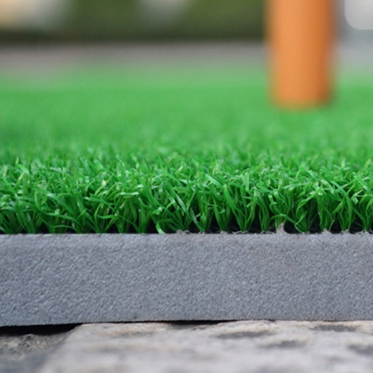 Close-up of green turf golf practice mat seam with dark foam backing