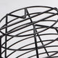 Close-up of black wire basket frame with arched top supports