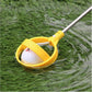 Yellow golf ball catcher hoop holding a golf ball, silver shaft and spring