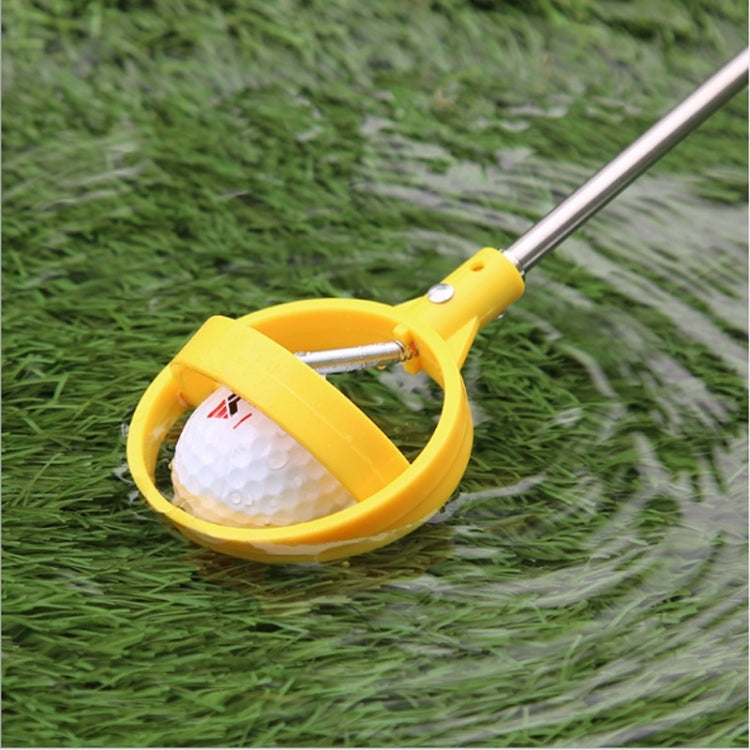 Yellow golf ball catcher hoop holding a golf ball, silver shaft and spring