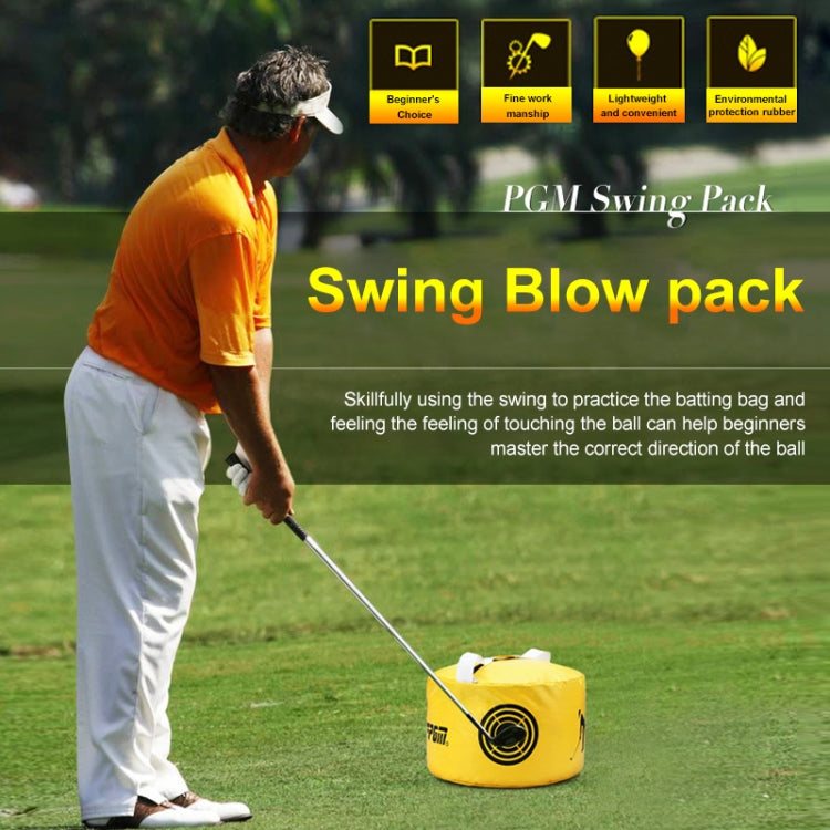 Yellow golf practice impact trainer bag beside a golfer on outdoor grass