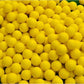 Yellow indoor golf rubber balls close-up showing dimpled texture