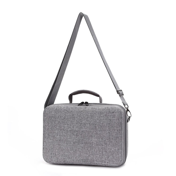 Gray fabric portable carry case with top handle and side zipper pocket.