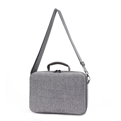 Gray fabric portable carry case with top handle and side zipper pocket.