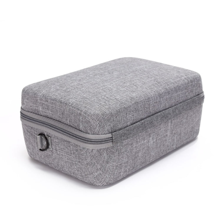Gray hardshell storage case with top lid and front zipper pocket.