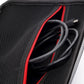 Interior mesh pocket with red trim and neatly stored cables inside gray case.