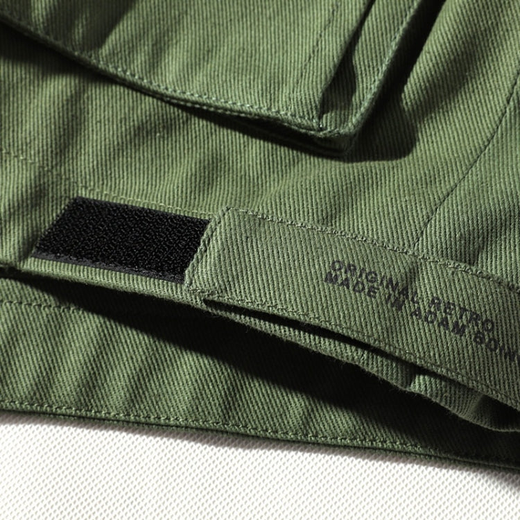 Green jacket chest pocket with flap detail and visible stitching