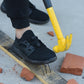 Black lace-up work safety shoes standing on a step with puncture-resistant spike points